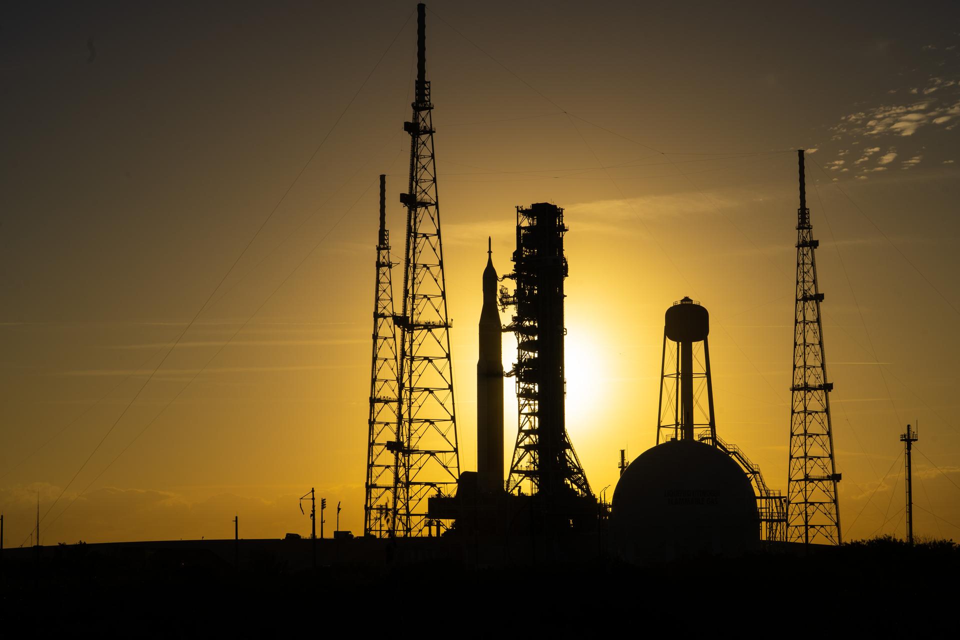 This image shows NASA’s SLS (Space Launch System) and Orion spacecraft rolling out of the Vehicle Assembly Building at NASA’s Kennedy Space Center. NASA's massive Crawler-Transporter, upgraded for the Artemis program, carries the powerful SLS rocket and Orion spacecraft on the Mobile Launcher from the Vehicle Assembly Building to Launch Pad 39B at Kennedy Space Center   in preparation for the Artemis II mission.  